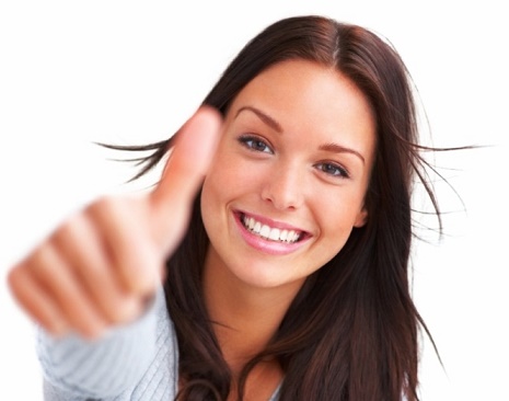 Portrait of attractive young female showing a thumbs up on white background